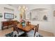 Bright dining room boasts beautiful chandelier and is adjacent to the kitchen at 1610 Monarch Dr # 1610, Venice, FL 34293