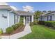 Charming home exterior featuring a well-maintained lawn, landscaped walkway, and a welcoming screened-in porch at 1610 Monarch Dr # 1610, Venice, FL 34293