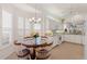 Well-lit kitchen and breakfast area featuring white cabinets, granite counters, and window shutters at 1610 Monarch Dr # 1610, Venice, FL 34293