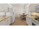 Bright kitchen and breakfast area featuring white cabinets, granite counters, and a stainless steel refrigerator at 1610 Monarch Dr # 1610, Venice, FL 34293