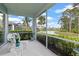 Covered lanai overlooking a serene lake and lush landscaping at 1610 Monarch Dr # 1610, Venice, FL 34293