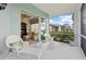 Cozy lanai with a glimpse into the home's interior and scenic views at 1610 Monarch Dr # 1610, Venice, FL 34293