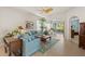 Bright living room boasts tile flooring, ceiling fan and view to lanai at 1610 Monarch Dr # 1610, Venice, FL 34293