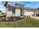 Charming single-Gathering home featuring a manicured lawn and two-car garage, complete with a brick paver driveway at 16131 Poplar Hill Ln, Port Charlotte, FL 33953