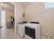 Laundry room with washer, dryer, and ample storage options at 16131 Poplar Hill Ln, Port Charlotte, FL 33953