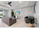 A modern living room is styled with comfortable seating, stylish decor, and a sleek ceiling fan at 16131 Poplar Hill Ln, Port Charlotte, FL 33953