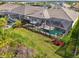 An aerial view features multiple homes with screened-in pools and outdoor dining at 18135 Home Run Dr, Venice, FL 34293