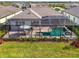 An aerial view showcasing a pool with outdoor seating at this home at 18135 Home Run Dr, Venice, FL 34293