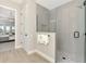 Modern bathroom with a glass-enclosed shower, and access to the bedroom at 18135 Home Run Dr, Venice, FL 34293