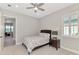 Neutral bedroom with tile floors, ceiling fan and access to the hallway at 18135 Home Run Dr, Venice, FL 34293
