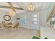 Elegant dining room with a modern chandelier, wood beam ceilings, and a bright window at 18135 Home Run Dr, Venice, FL 34293
