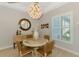 Charming dining area featuring a decorative light fixture, modern window shutters, and stylish décor at 18135 Home Run Dr, Venice, FL 34293