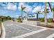 Well-manicured entryway with Gran Place signage, decorative flowers and tropical palm trees at 18135 Home Run Dr, Venice, FL 34293