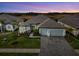 Stunning exterior view of home, showcasing a brick driveway, manicured lawn, and a two-car garage at 18135 Home Run Dr, Venice, FL 34293