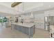 Well-lit kitchen with a center island, stainless steel appliances, and an adjacent dining area at 18135 Home Run Dr, Venice, FL 34293