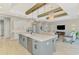Open-concept kitchen showcasing an island, stainless steel appliances, and seamless access to the living area at 18135 Home Run Dr, Venice, FL 34293