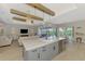 Open kitchen with a large center island and a view of the living room and outdoor pool at 18135 Home Run Dr, Venice, FL 34293