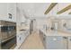 Spacious, open concept white kitchen with a large island, pendant lighting, and modern appliances at 18135 Home Run Dr, Venice, FL 34293