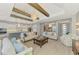 Open concept living room featuring a large sliding glass door and a view of the kitchen at 18135 Home Run Dr, Venice, FL 34293
