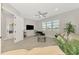 Open living room with tile flooring, ceiling fan, and neutral paint at 18135 Home Run Dr, Venice, FL 34293