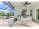 Exterior kitchen with stainless steel grill, prep space and seating for dining at 18135 Home Run Dr, Venice, FL 34293