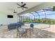 Outdoor patio with comfortable seating, ceiling fans, and a screened-in pool and hot tub area at 18135 Home Run Dr, Venice, FL 34293