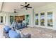 Covered outdoor patio with modern furniture, ceiling fans, and access to the interior of the home at 18135 Home Run Dr, Venice, FL 34293