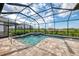 A stunning screened-in pool features a spa and stylish brick patio at 18135 Home Run Dr, Venice, FL 34293
