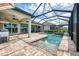 A gorgeous screened-in pool with an outdoor kitchen and seating at 18135 Home Run Dr, Venice, FL 34293
