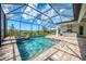 A stunning screened-in pool with a spa and outdoor kitchen at 18135 Home Run Dr, Venice, FL 34293