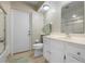 Bathroom featuring ample storage in vanity, a shower with glass doors, and direct exterior access at 1915 Pebble Beach Ct, Venice, FL 34293