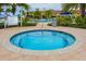 Inviting hot tub with lounge chairs and lush tropical landscaping at 19248 Isadora St, Venice, FL 34293