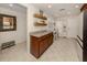 Bright kitchen with wood shelves, granite countertops, and eating area at 19248 Isadora St, Venice, FL 34293