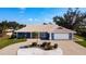 Charming single-Gathering home features a two-car garage, circular drive, and beautiful landscaping at 2 Windsor Dr, Englewood, FL 34223