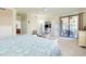 Spacious bedroom featuring access to lanai, ensuite bathroom, and comfortable seating at 20181 Ragazza Cir # 101, Venice, FL 34293