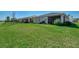 Manicured lawn and a fenced backyard, backing onto a serene pond at 20420 Symphony Pl, Venice, FL 34293