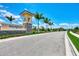 Elegant community entrance marked by 'Renaissance' signage, enhanced by swaying palm trees and impeccable landscaping at 20420 Symphony Pl, Venice, FL 34293