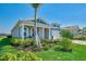 Quaint one-story home featuring lush landscaping, healthy lawn, and a two-car garage at 20420 Symphony Pl, Venice, FL 34293