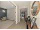 Well-lit foyer featuring luxury vinyl floors, open doorway, and an adjacent sitting room at 20420 Symphony Pl, Venice, FL 34293