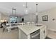 Spacious kitchen island with stainless dishwasher overlooks the dining and living area at 20420 Symphony Pl, Venice, FL 34293