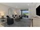 Comfortable living room with ample seating, a large window, and a view to the exterior lanai at 20420 Symphony Pl, Venice, FL 34293