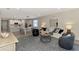 Open floor plan showcasing the kitchen, dining, and living spaces in neutral tones and modern furnishings at 20420 Symphony Pl, Venice, FL 34293