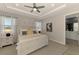 A serene main bedroom features a ceiling fan and an ensuite bathroom at 20420 Symphony Pl, Venice, FL 34293