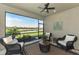 Screened patio offers a peaceful view of the water, complete with wicker furniture and lush landscaping at 20420 Symphony Pl, Venice, FL 34293