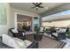 Spacious screened-in patio with wicker seating, opening to the home's interior at 20420 Symphony Pl, Venice, FL 34293