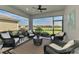 Relaxing screened-in patio featuring comfortable wicker furniture and serene views of the water at 20420 Symphony Pl, Venice, FL 34293