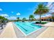 Beautiful community pool surrounded by palm trees and lounge chairs, perfect for relaxation at 20420 Symphony Pl, Venice, FL 34293