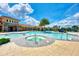 Community pool area with a jacuzzi and a large lounging area at 20420 Symphony Pl, Venice, FL 34293