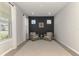 Bright sitting room showcasing two chairs, natural light, and contemporary decor at 20420 Symphony Pl, Venice, FL 34293