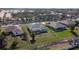 Birds eye view of a green backyard with a screened in enclosure and neighboring houses in a residential neighborhood at 2115 Pan American Blvd, North Port, FL 34287